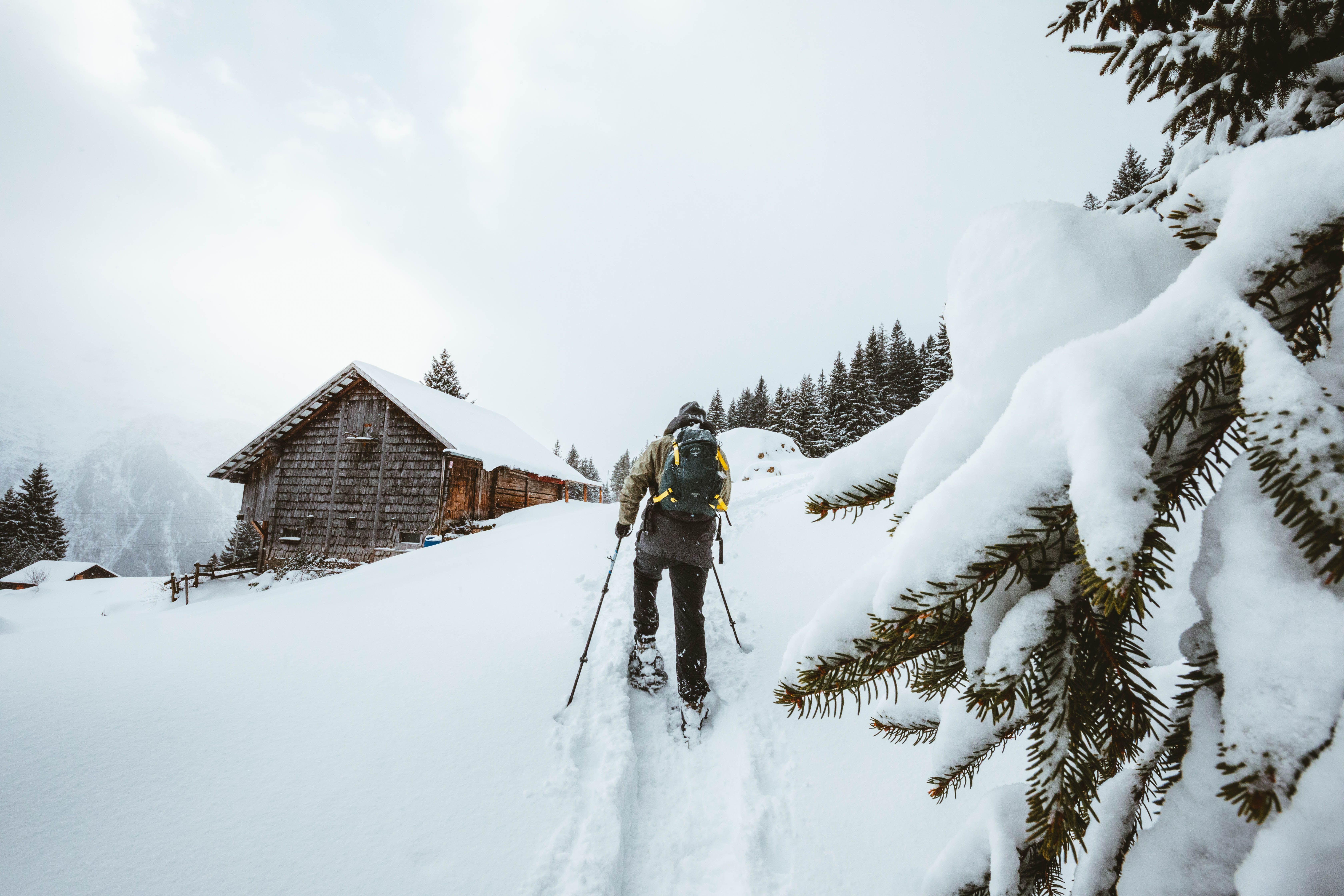 A skier performs a thrilling jump off a snowy mountainside, showcasing extreme winter sports.