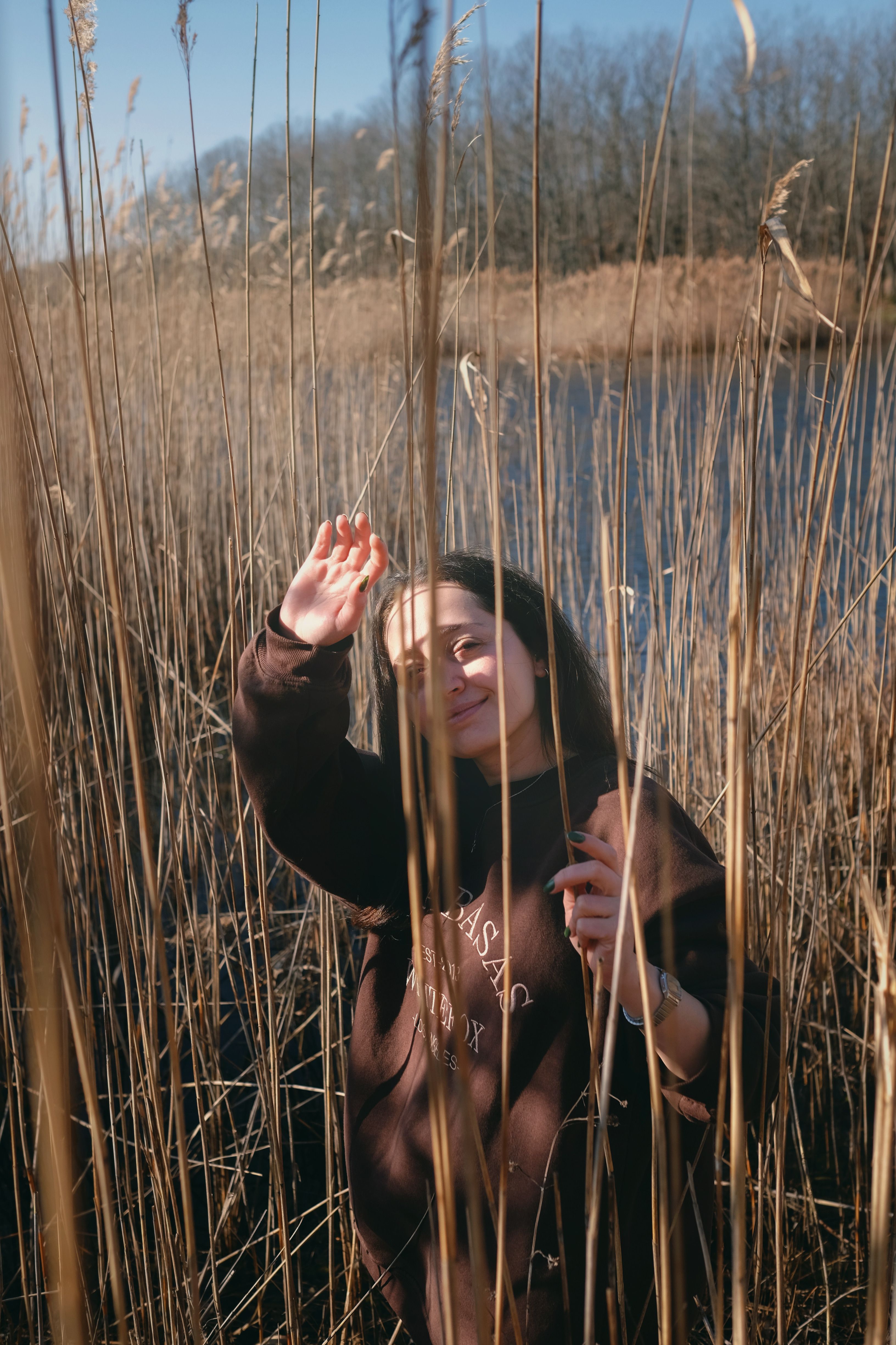 Woman in Brown Long Sleeve Shirt Standing on Grass Field · Free Stock Photo