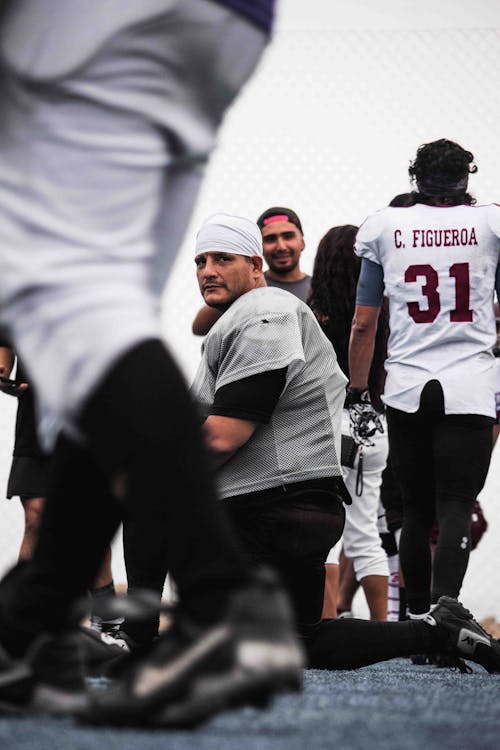 Group of American Footballers Walking on a Field 