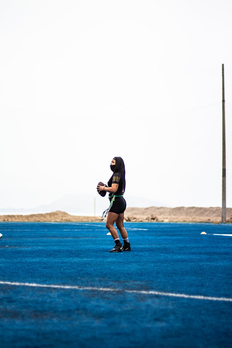 Woman Playing Rugby On Field