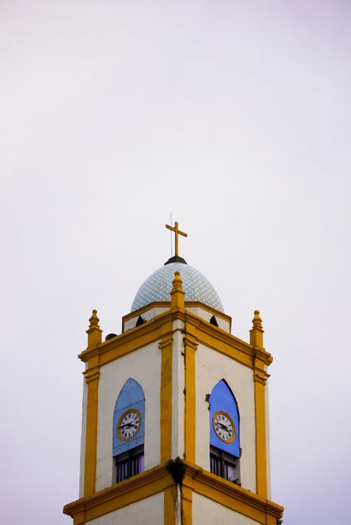 Free Low angle view of a church tower topped with a cross in Papantla, Ver., Mexico. Stock Photo