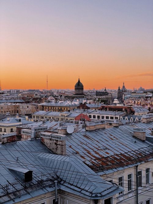 Free Capturing the scenic rooftops of St. Petersburg at sunset with a warm sky. Stock Photo
