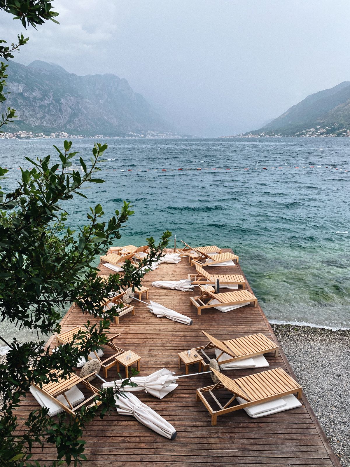 Sunbeds on a wooden terrace on a Montenegrin beach — the slow Adriatic afternoon by the water