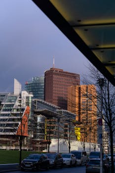 Street view of modern architecture in Berlin with parked cars and urban landscape.