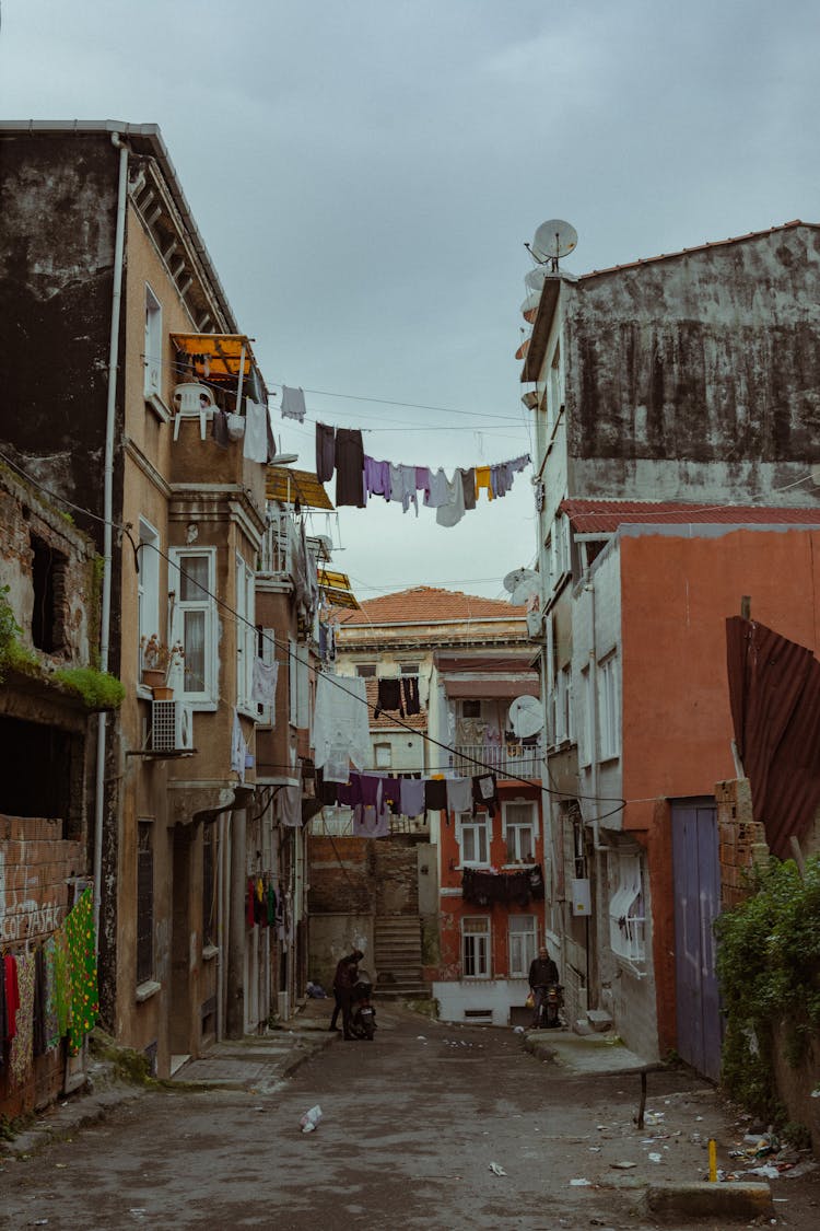 Clothes Hanging Between Houses On Poor City Street