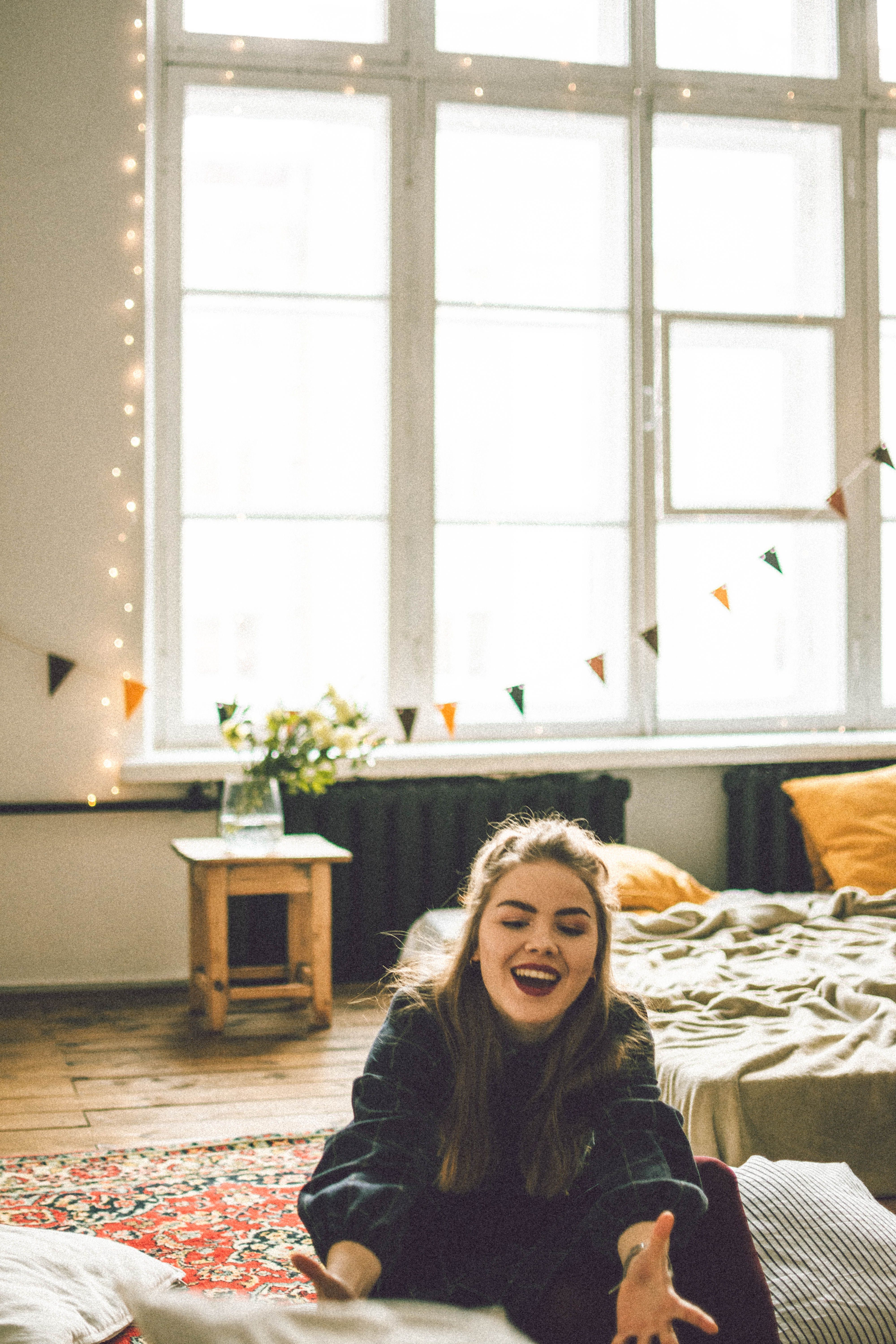 Photo of a Smiling Girl Sitting on the Floor · Free Stock Photo