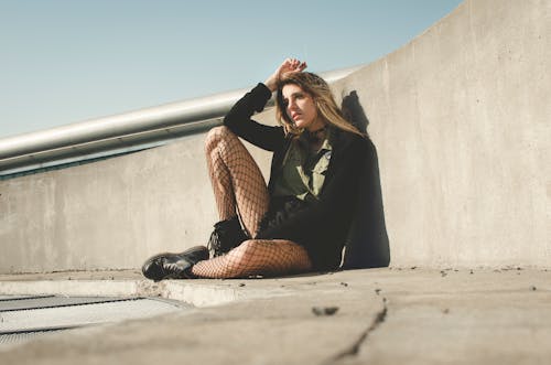 Free Photography of a Woman Leaning on a Wall Stock Photo