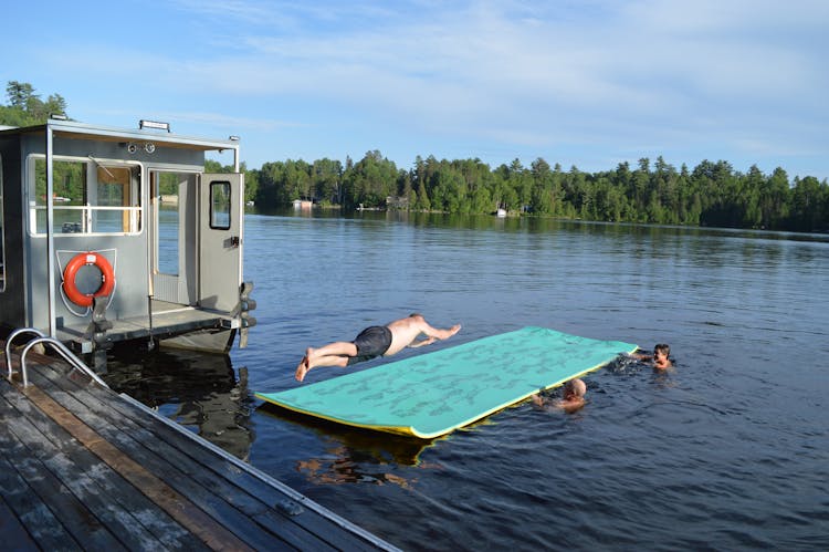 Man Jumping On A Matres On A Lake