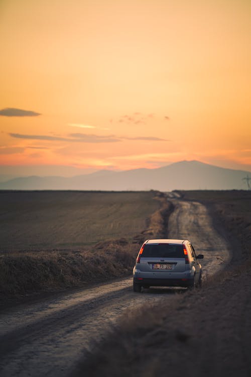 Moving Car on the Road during Sunset