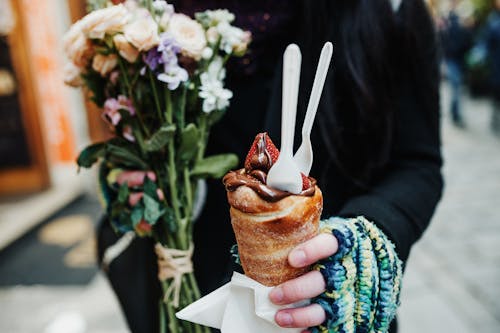 Close-up of Woman Holding Pastry with Chocolate