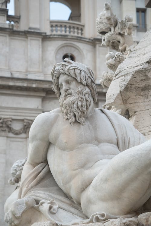 Classicist Male Sculpture and Building in Background