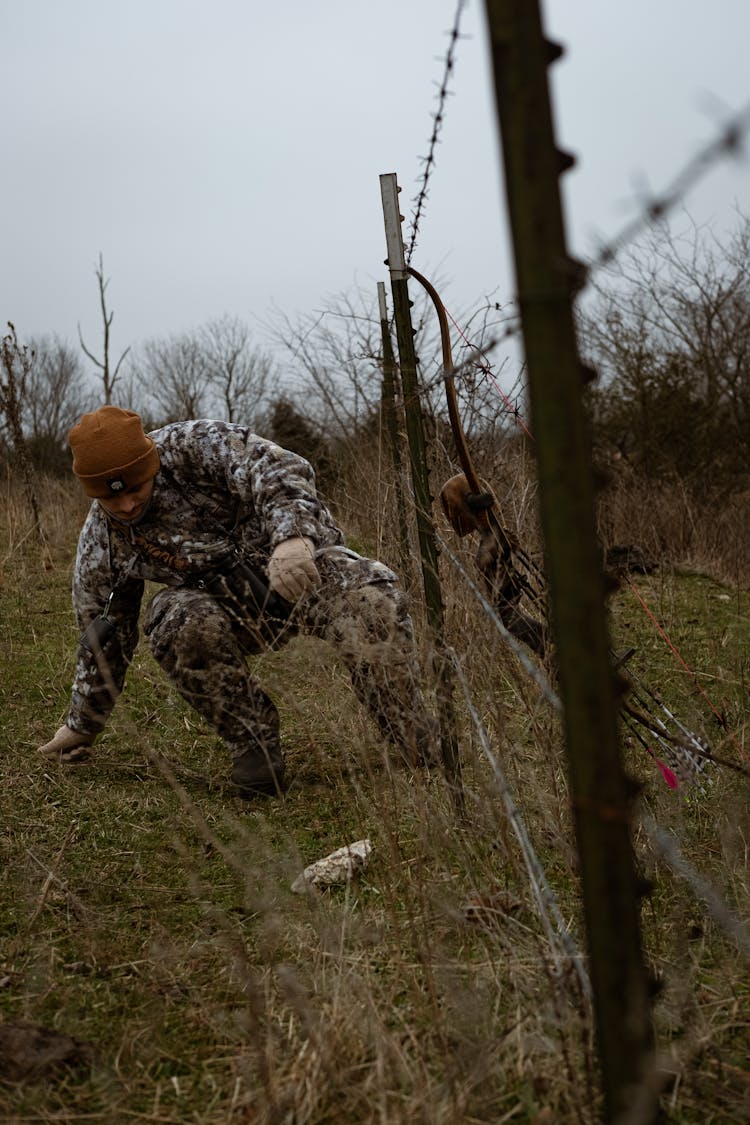 Soldier Sneaking Under Fence