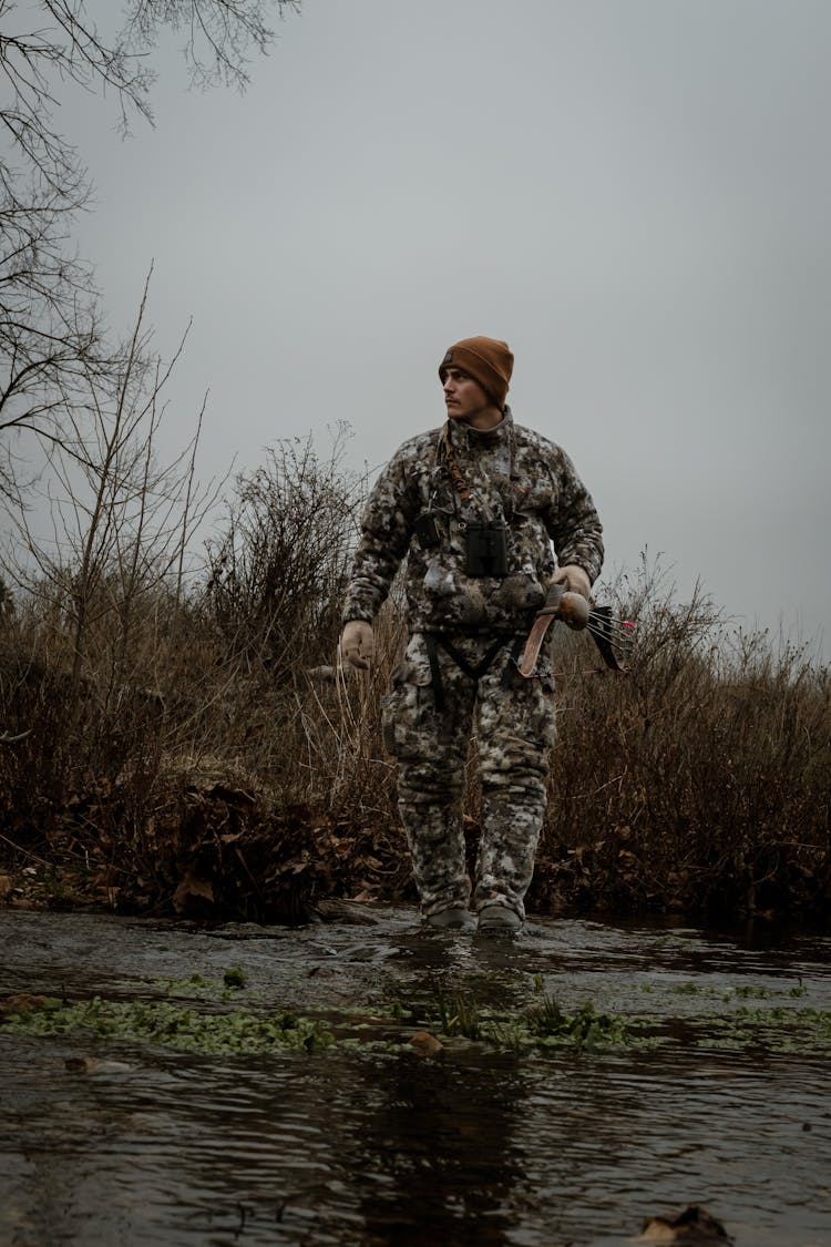 A Hunter Crossing A River