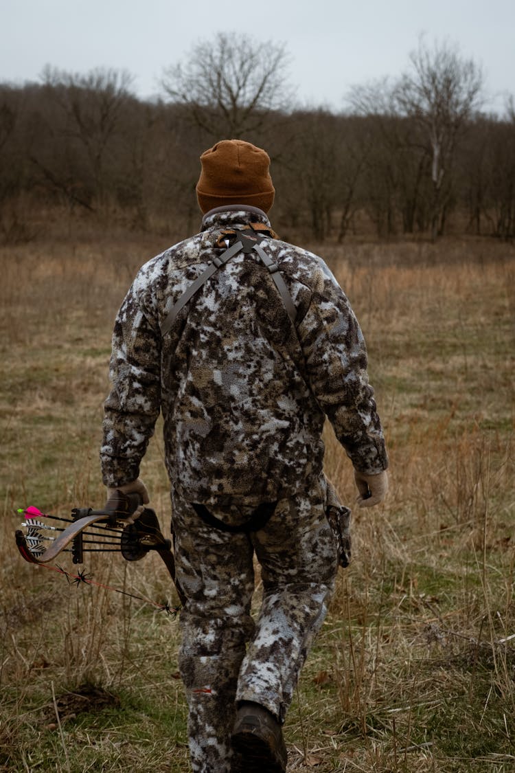 A Hunter Walking On A Field