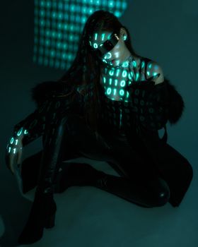 Dark futuristic portrait of a woman wearing sunglasses with binary code projection.