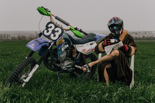 Free Rider sitting beside his Dirtbike Stock Photo