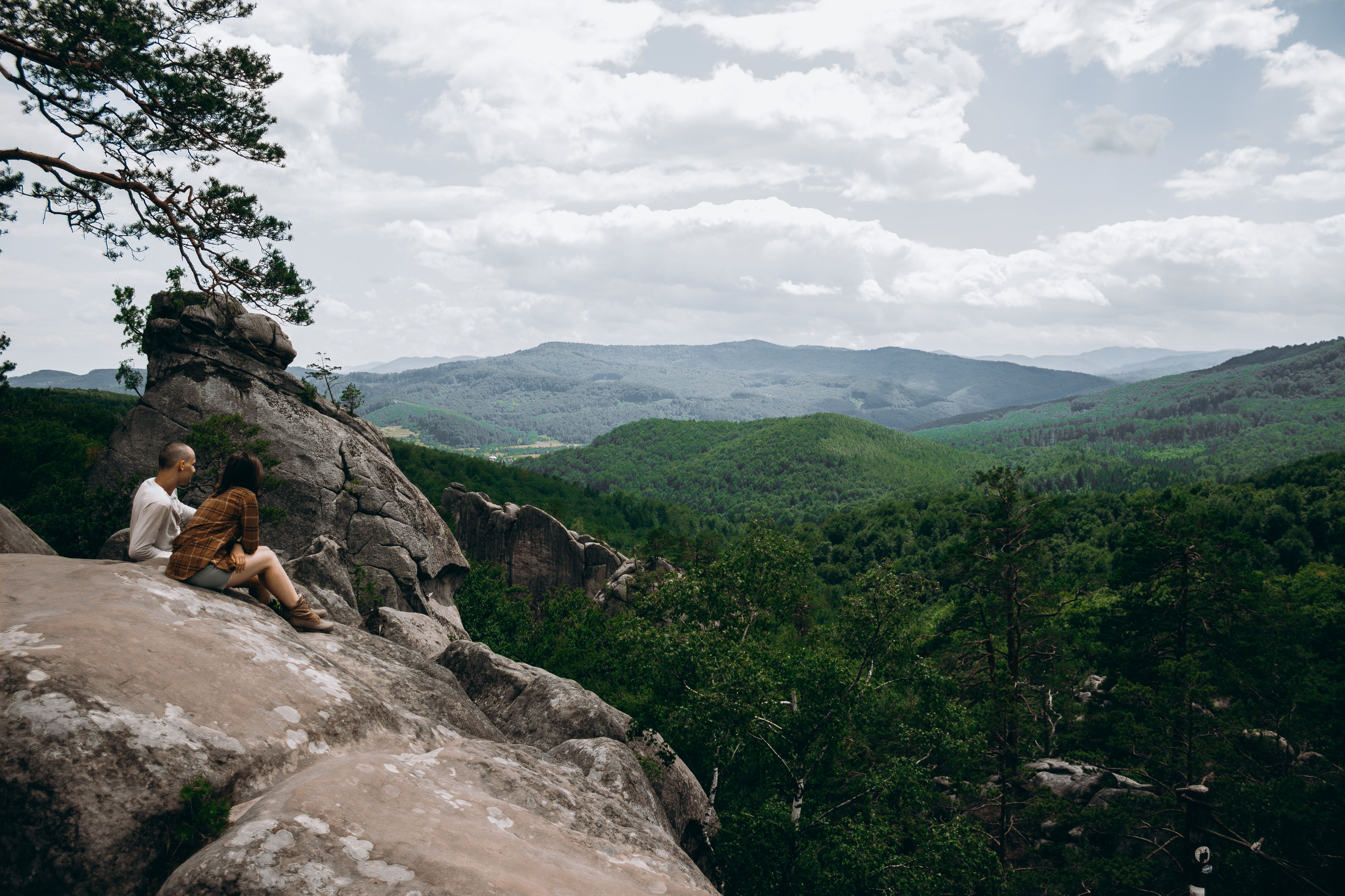 Couple sitting on a Rock Cliff · Free Stock Photo
