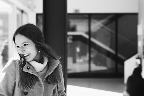 Woman in Gray Jacket Near Black Board