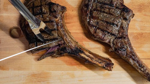 Free Close-up Photo of Grilled Meat on Brown Wooden Surface Stock Photo