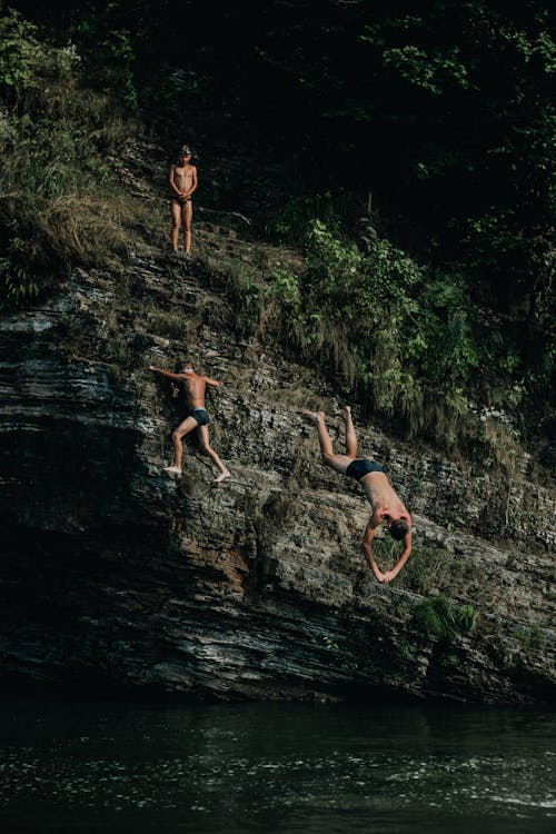 Boys Diving from Rock Formation