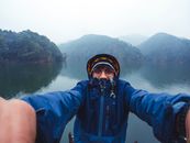 Person in Blue Jacket taking a Selfie