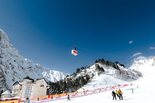 Gondola Ski Lift Going Over the Skiers