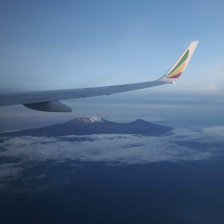 Airplane Flying Over Mountain