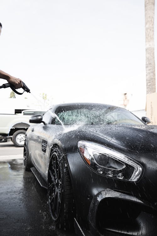 Free Person Cleaning Black Car  Stock Photo