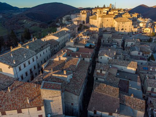 Free Breathtaking aerial view of a traditional Italian town with classic architecture and scenic hills. Stock Photo