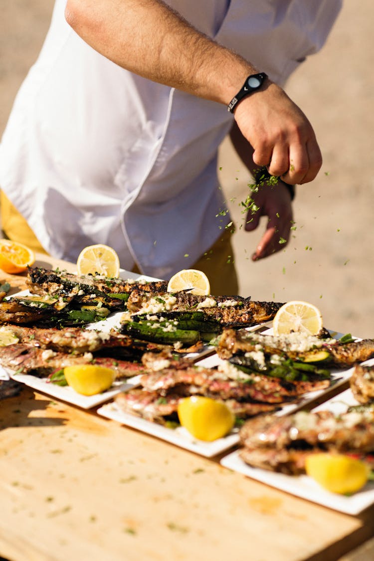 Man Seasoning Fish Dishes