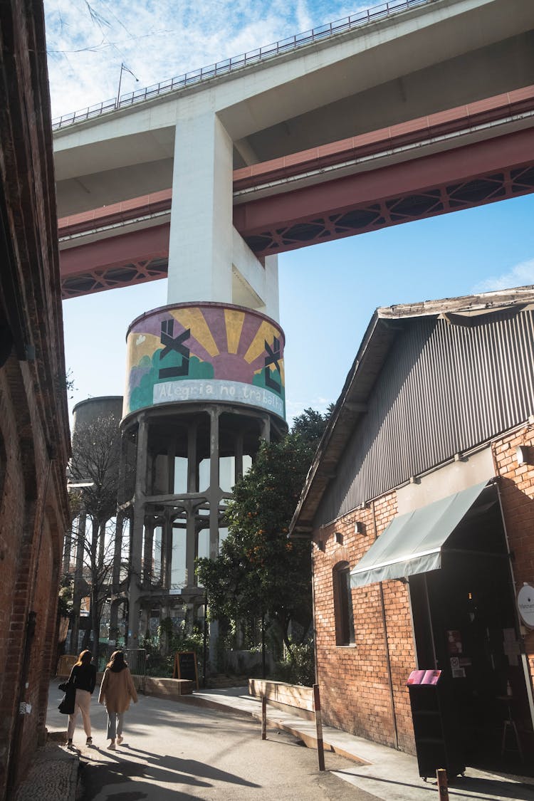 Colorful Pillar Holding Up Bridge Above Buildings