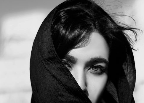 Grayscale close-up portrait of a woman wearing a hijab in Tehran, Iran.