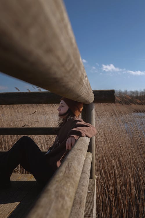 A Woman Leaning on a Tree Log