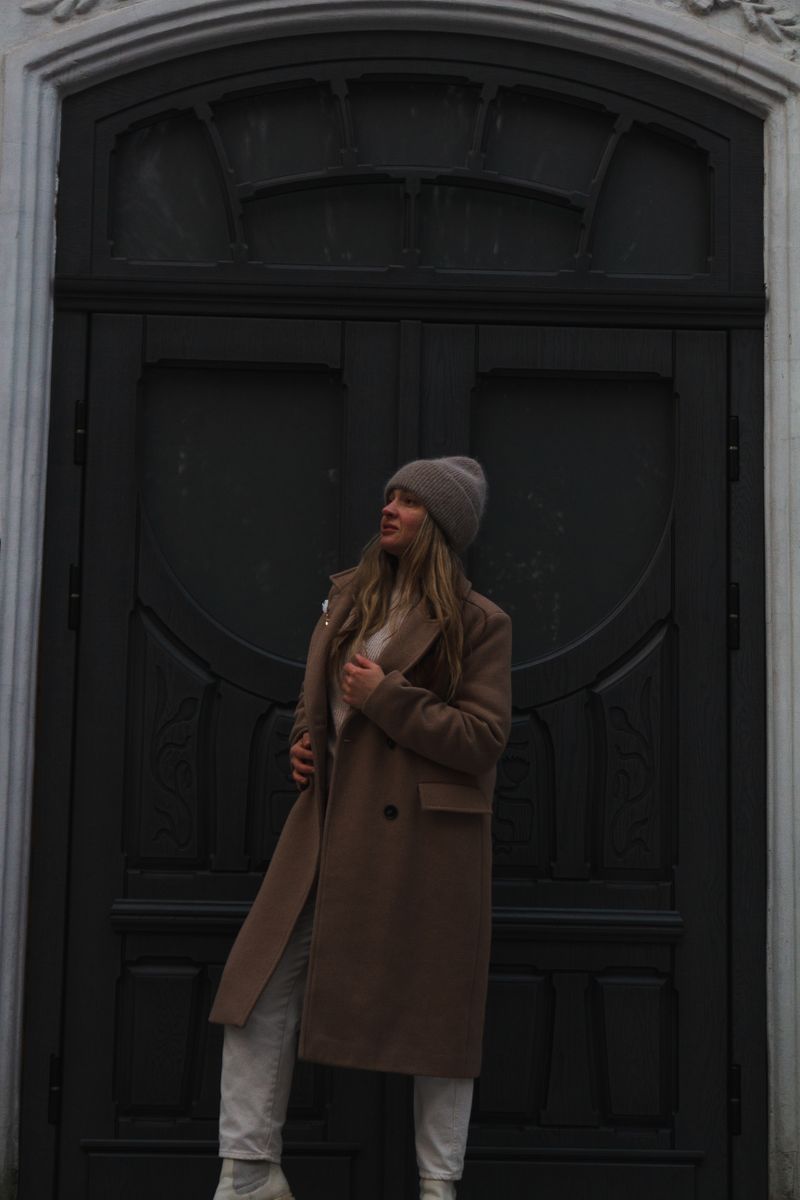 Woman in brown coat and beanie