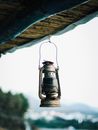 Black Lantern Hanging on Blue Roof