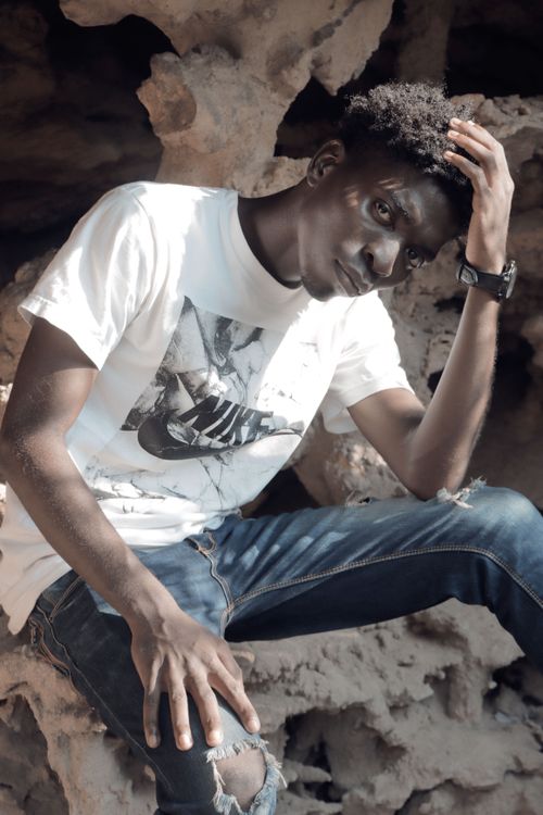Free A fashionable young man posing confidently in an outdoor setting, wearing a casual outfit. Stock Photo