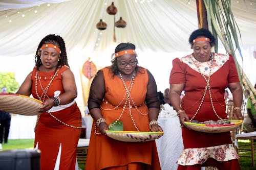 Women Dancing and Holding Trays at a Traditional Celebration 