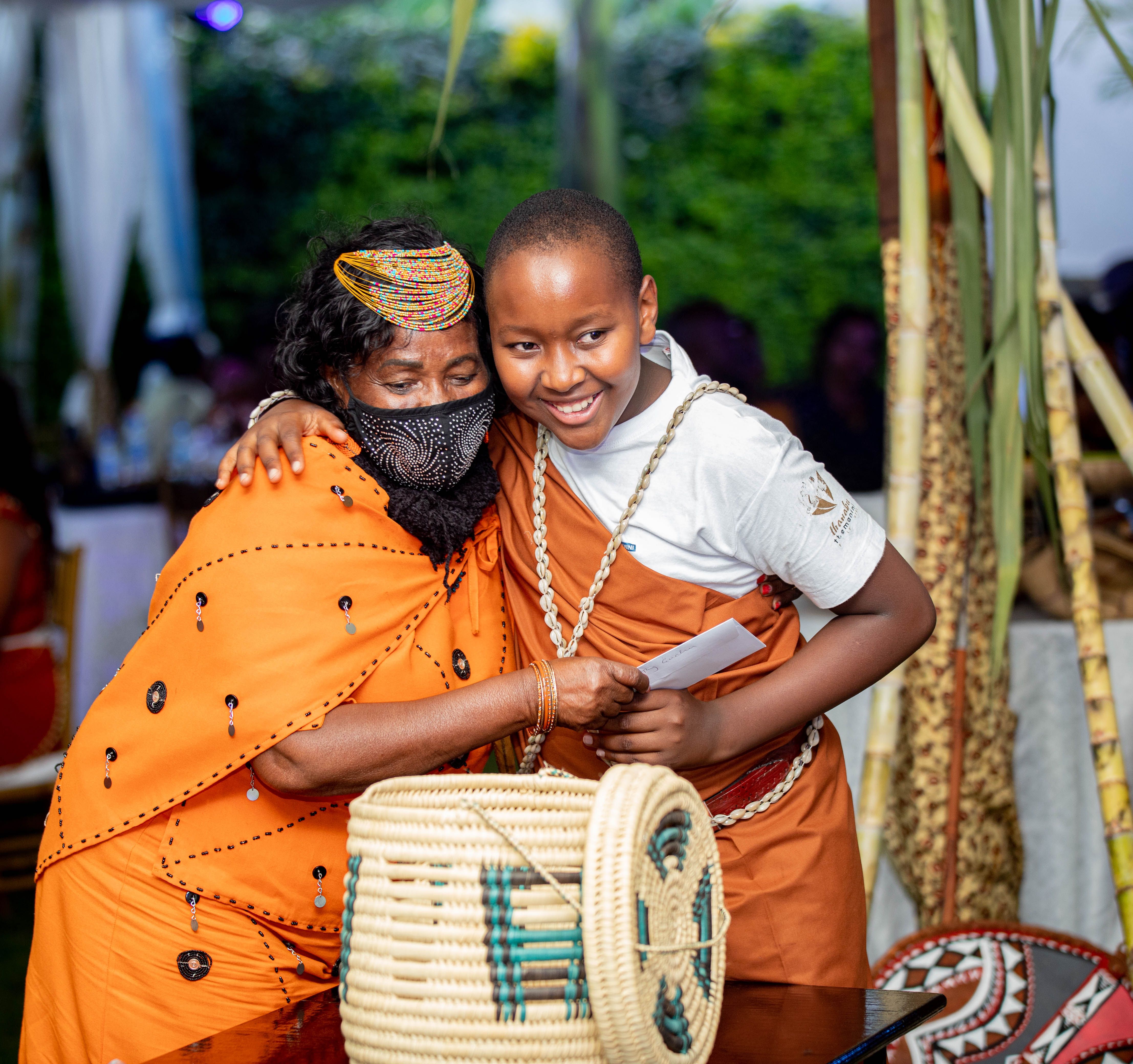 A touching moment between two people in vibrant traditional wear, celebrating joy and connection.