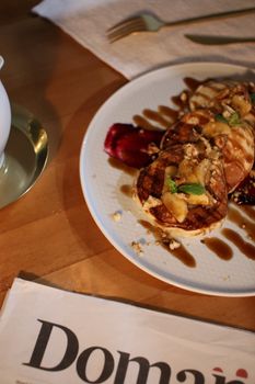 A mouthwatering plate of pancakes topped with bananas and syrup, perfect for breakfast enthusiasts.
