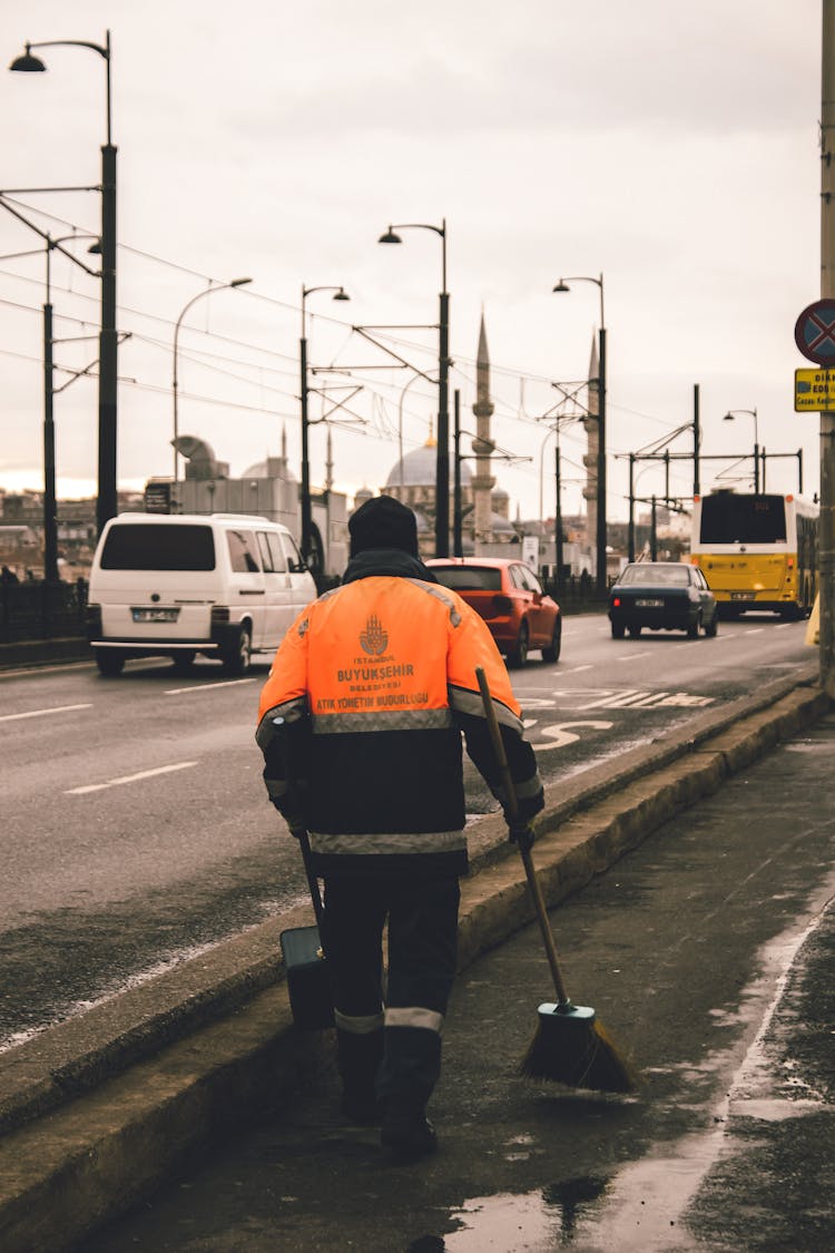 Man Cleaning The Side Of A Street 