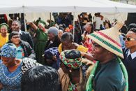 Colorful outdoor festival scene in South Africa with joyful crowd celebrating.