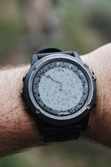 Close-up of a rugged GPS outdoor watch with water droplets