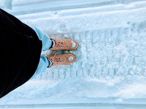 Free Person Wearing a Brown Hiking Shoes Standing on Snow Stock Photo