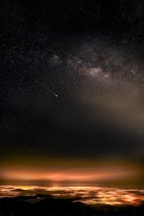 Starry Sky Over an Illuminated Land 