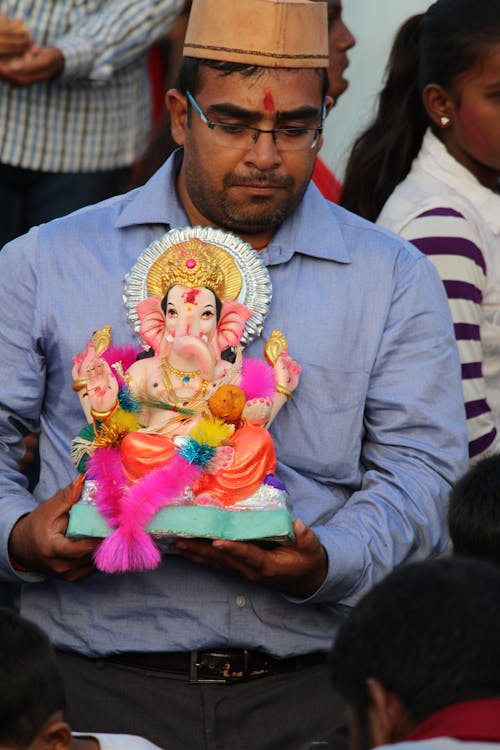 Man Holding a Ganesh Statue 