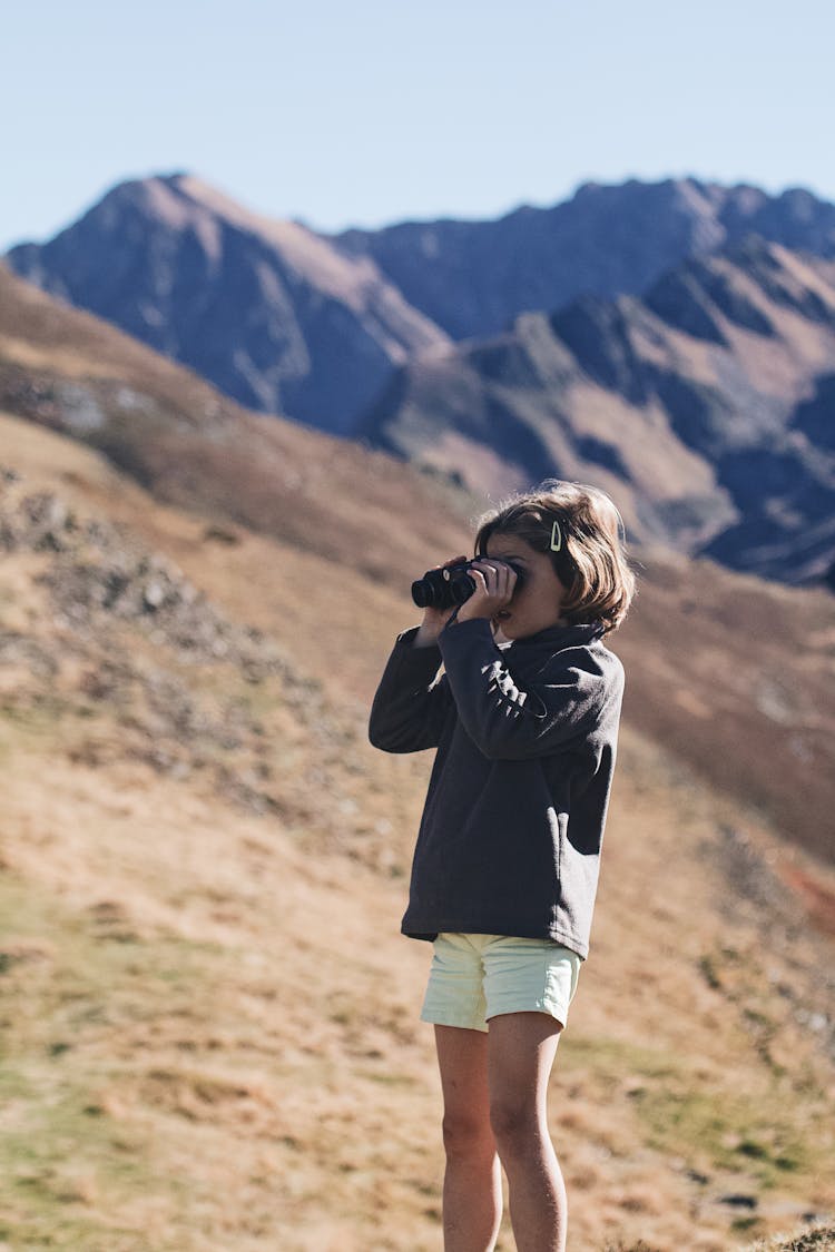 Child Using Black Binoculars