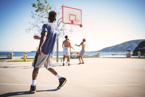 Four People Playing Basketball