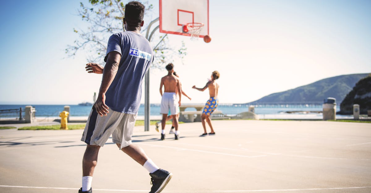 Four People Playing Basketball