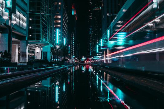 Captivating long exposure of Houston's urban landscape with vibrant city lights reflecting on the streets.