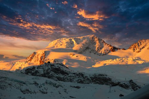 Free Breathtaking view of a snow-covered mountain at sunset with vibrant sky. Stock Photo